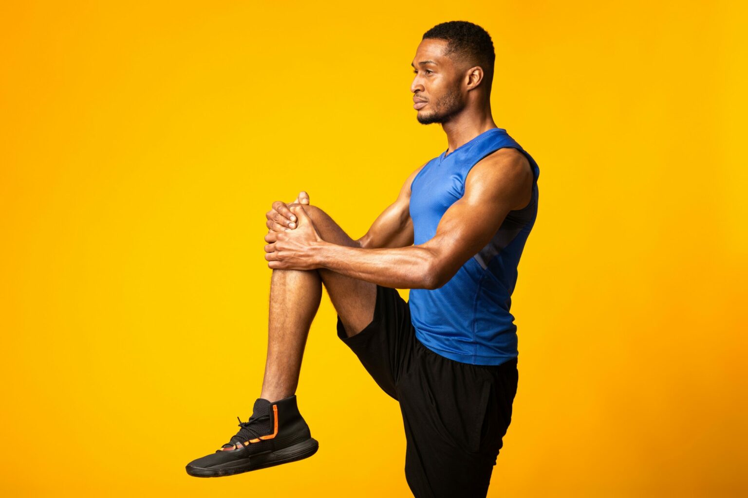 athlete doing warm-up exercise with a yellow background (not original photo)